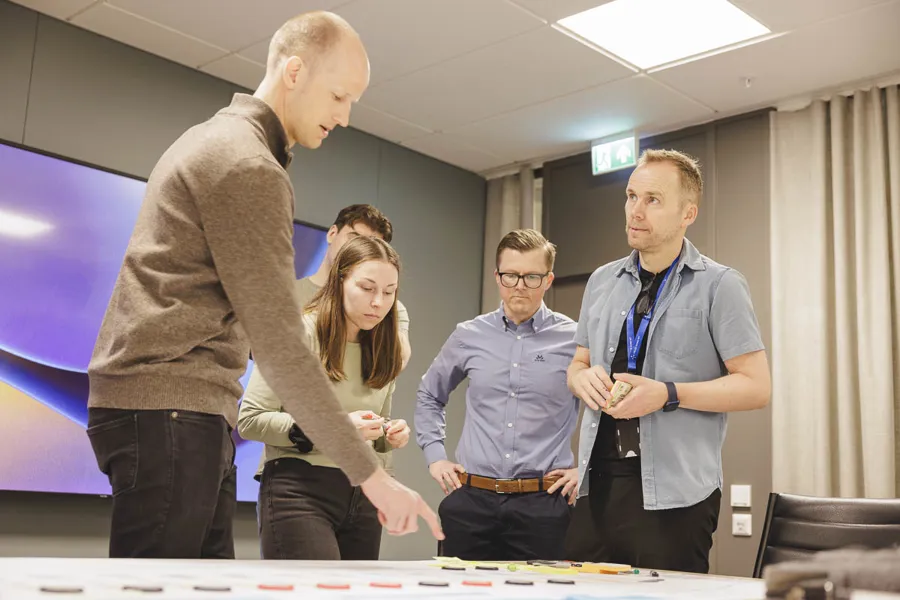 En gruppe mennesker som står rundt et bord